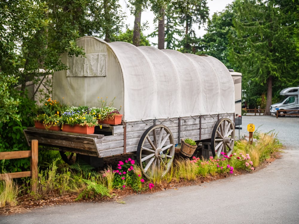 The Pioneer Trails covered wagon and flowers at the park entrance